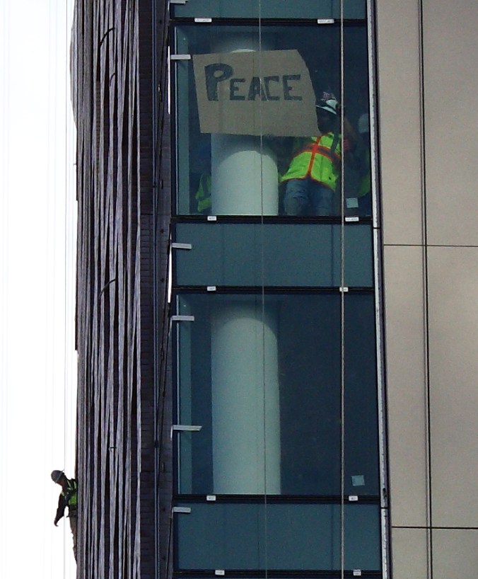 Construction workers above the march.