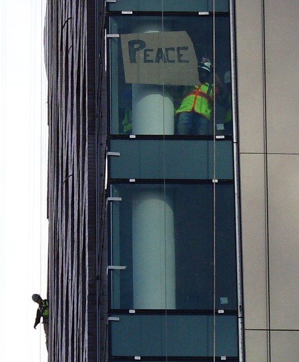 Construction workers above the march.